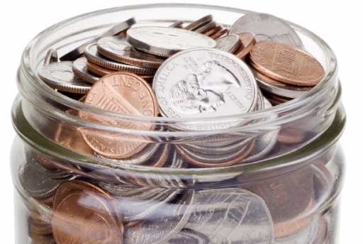 A jar full of coins.  With clipping path.