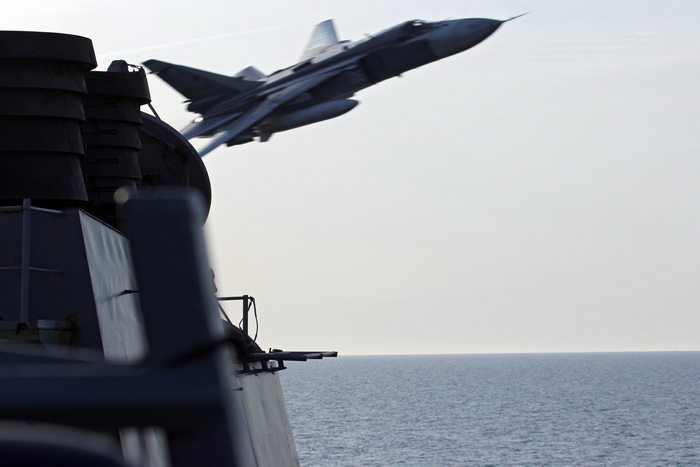epa05257585 A handout image made available on 13 April 2016 by the US Navy shows a Russian Sukhoi Su-24 attack aircraft making a very low altitude pass by USS Donald Cook (DDG 75) in the Baltic Sea, 12 April 2016. Donald Cook, an Arleigh Burke-class guided-missile destroyer forward deployed to Rota, Spain, is conducting a routine patrol in the U.S. 6th Fleet area of operations in support of U.S. national security interests in Europe.  EPA/US NAVY / HANDOUT  HANDOUT EDITORIAL USE ONLY