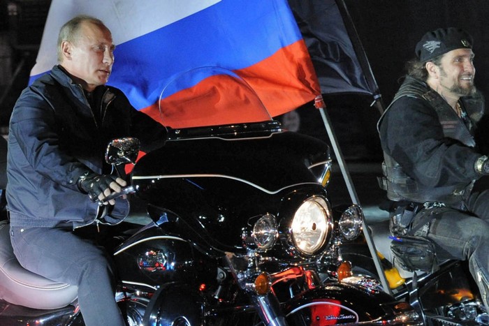 Russian Prime Minister Vladimir Putin (L) rides a motorbike as he takes part in the 16th annual motorbike festival held by "The Night Wolves" youth organization in the southern Russian town of Novorossiysk, on August 29, 2011. AFP PHOTO / RIA NOVOSTI / POOL / ALEXEY DRUZHININ (Photo credit should read ALEXEY DRUZHININ/AFP/Getty Images)