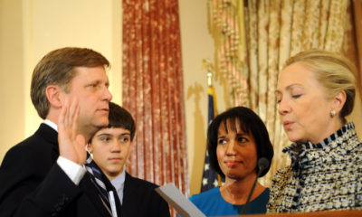 WASHINGTON, DC - JANUARY 10:  U.S. Secretary of State Hillary Clinton (R) gives the oath of office to Ambassador-Designate to Russia Michael McFaul (L) as his wife Donna Norton (2R) looks on at the State Department January 10, 2011 in Washington, DC. McFaul is President Barack Obama's top adviser on Russia and has been involved in the reset of relations between the two countries and the signing of the New START treaty.  (Photo by Astrid Riecken/Getty Images)