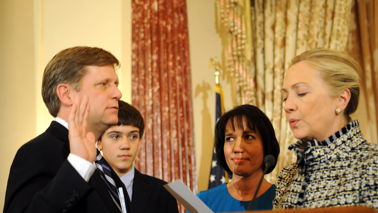 WASHINGTON, DC - JANUARY 10:  U.S. Secretary of State Hillary Clinton (R) gives the oath of office to Ambassador-Designate to Russia Michael McFaul (L) as his wife Donna Norton (2R) looks on at the State Department January 10, 2011 in Washington, DC. McFaul is President Barack Obama's top adviser on Russia and has been involved in the reset of relations between the two countries and the signing of the New START treaty.  (Photo by Astrid Riecken/Getty Images)