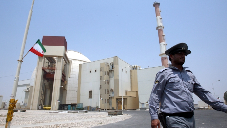 epa05070463 (FILE) A file photograph showing an Iranian security officer walking in front of the nuclear power plant in Bushehr , southern Iran on 21 August 2010. Media reports on 15 December 2015 state that the 35 countries on the governing board of the International Atomic Energy Agency (IAEA) unanimously took note of the agency's recent final report on its inquiry, which found that Iran had conducted various nuclear weapons research projects that have now ended.  EPA/ABEDIN TAHERKENAREH *** Local Caption *** 51186417