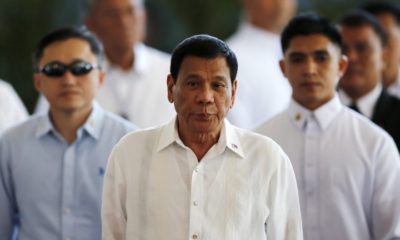 epa05601569 Filipino President Rodrigo Duterte (C) is escorted during a departure ceremony at Manila's international airport, Philippines, 25 October 2016. Duterte leaves for Japan to meet Prime Minister Shinzo Abe. The two are expected to agree on expanding bilateral ties in areas of maritime security and defense cooperation, according to news reports.  EPA/FRANCIS R. MALASIG