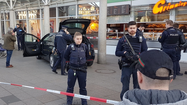 epaselect epa05815184 Police officers stand in front of a car in Heidelberg, Germany, 25 February 2017. The driver steered the car into a group of people. This resulted in three people being injured, one of them being seriously injured. Later the suspect was arrested by the police. The man was shot by the police and is seriously injured in a Heidelberg hospital.  EPA/RENE PRIEBE