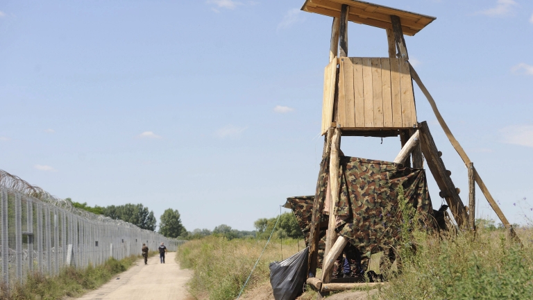 epa05409606 A Hungarian soldier and policemen patrol the border fence between Hungary and Serbia near Asotthalom, Hungary, 05 July 2016. On this day the Hungarian authorities introduced new border regulations, which are in line with the government's goal, to stem the uncontrolled inflow of illegal migrants. The new law aims to ensure that no one enters the country illegally but guarantees migrants an opportunity to submit asylum requests. Under the law, illegal entrants stopped within eight kilometres of the border will be escorted back over the border and offered an opportunity to apply for asylum at a transit zone. Migrants who comply with authorities, and apply for asylum, will not be expelled from the country and their appeals will be processed without delay.  EPA/EDVARD MOLNAR HUNGARY OUT