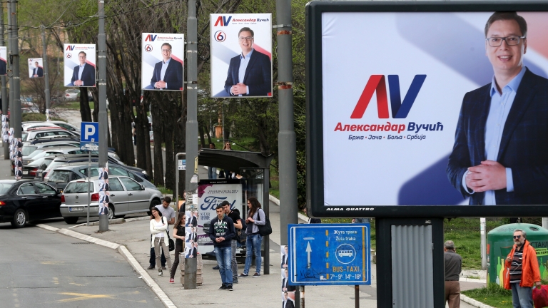 epa05866294 People wait at a bus station next to billboards of Serbian Progressive Party candidate for the Serbian presidency, Aleksandar Vucic in Belgrade, Serbia, 23 March 2017. Presidential election is scheduled to take place on 02 April 2017.  EPA/KOCA SULEJMANOVIC