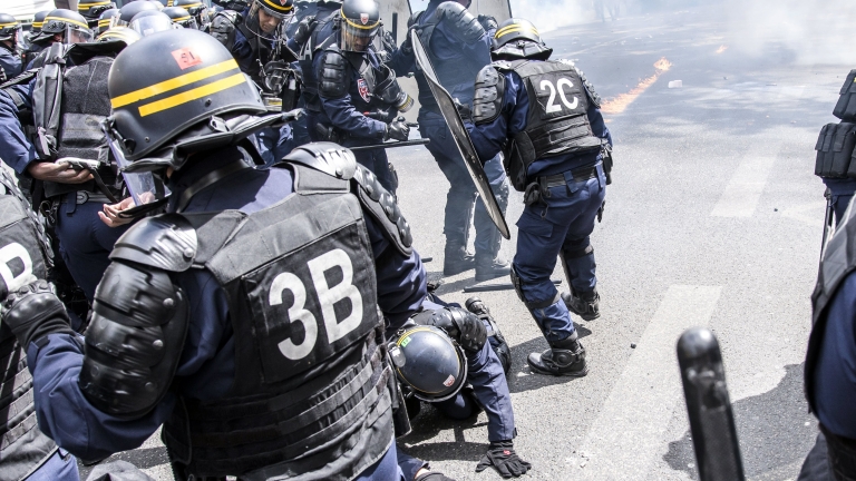 epa05939101 A French anti riot officer falls on the ground as clashes erupt between protesters and French anti-riot police during a May Day demonstration against French far-right in Paris, France, 01 May 2017. Thousands of people demonstrated against the presence of Far-right Front National (FN) party candidate Marine Le-Pen for the second turn of the presidential elections. Labor Day or May Day is observed all over the world on the first day of the May to celebrate the economic and social achievements of workers and fight for laborers rights.  EPA/CHRISTOPHE PETIT TESSON