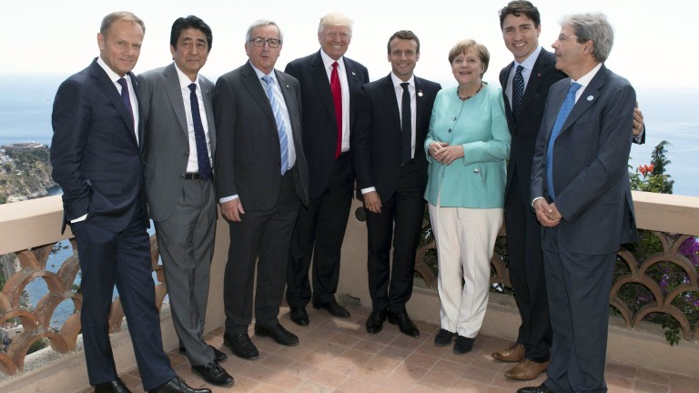 epa05992914 A handout photo made available by the Chigi Palace Press office on 27 May 2017 shows the G7 and Europe leaders with (L-R) European Council President Donald Tusk, Japanese Prime Minister Shinzo Abe, European Commission President Jean-Claude Juncker, US President Donald J. Trump, French President Emmanuel Macron, German Chancellor Angela Merkel, Canada's Prime Minister Justin Trudeau and hosting Italian Prime Minister Paolo Gentiloni standing together for a group photo during the G7 Summit extended session in the Sicilian town of Taormina, Italy, on its second day on 27 May 2017. The second day is scheduled to deal with Innovation and Development in Africa, Global Issues such as Human Mobility, Food Security and Gender Equality as well as the G7 Global Relations,  the Italian G7 Presidency said in a media release.  EPA/TIBERIO BARCHIELLI/CHIGI PRESS OFFICE HANDOUT  HANDOUT EDITORIAL USE ONLY/NO SALES