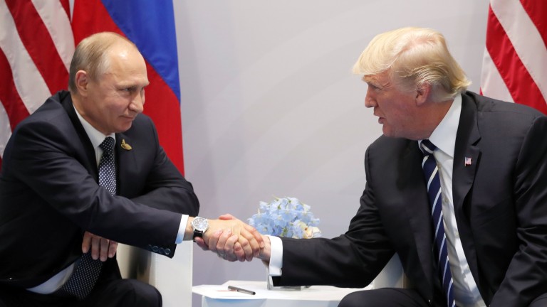 epaselect epa06073306 Russian President Vladimir Putin (L) and US President Donald J. Trump (R) shake hands during a meeting on the sidelines of the G20 summit in Hamburg, Germany, 07 July 2017. The G20 Summit (or G-20 or Group of Twenty) is an international forum for governments from 20 major economies. The summit is taking place in Hamburg from 07 to 08 July 2017.  EPA/MICHAEL KLIMENTYEV / SPUTNIK / KREMLIN POOL / POOL MANDATORY CREDIT