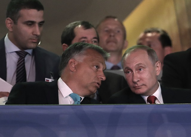 Russian President Vladimir Putin, right, talks to Hungarian Prime Minister Viktor Orban, left, after arriving at the World Judo Championships as they meet in Budapest, Hungary, Monday, Aug. 28, 2017. (AP Photo/Petr David Josek)