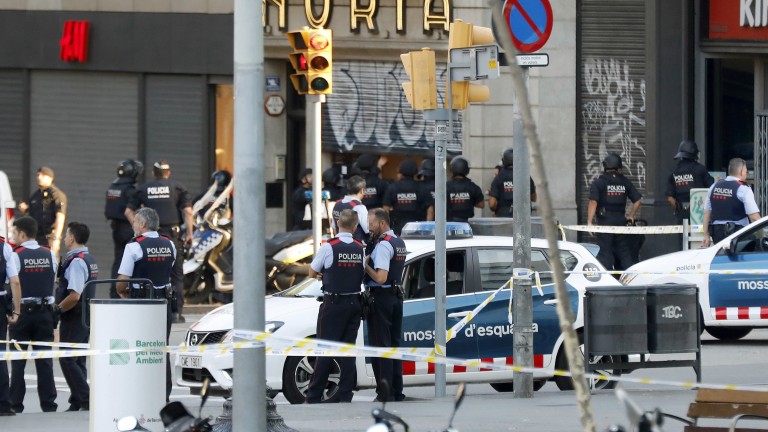 epa06148826 Police officers and emergency service workers set up a security perimeter near the site where a van crashes into pedestrians in Las Ramblas, downtown Barcelona, northeastern Spain, 17 August 2017. At least 13 people have died in the terrorist attack.  EPA/Andreu Dalmau FACES PIXELATED BY SOURCE DUE TO SPANISH LAW