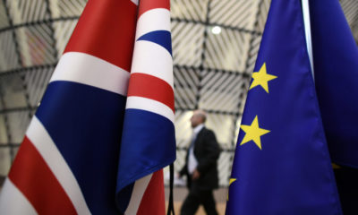 BRUSSELS, BELGIUM - MARCH 09:  A man walks past British and European Union flags in the arrival area of the Europa building at the Council of the European Union on the first day of an EU summit, on March 9, 2017 in Brussels, Belgium. EU leaders will gather for a two-day summit to discuss a number of issues including Great Britain's exit from the Union.  (Photo by Carl Court/Getty Images)