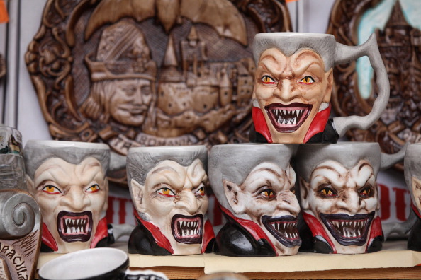 BRAN, ROMANIA - MARCH 10:  Mugs bearing a rendition of Dracula are displayed at a souvenir shop at Bran Castle, famous as "Dracula's Castle," on March 10, 2013 in Bran, Romania. Bran Castle's reputation as the supposed home to Dracula corresponds little with Bram Stoker's novel, nor did Vlad Tepes, the sadistic 15th-century Wallachian prince, ever live there. Nevetheless the castle retains the myth and tourists flock there in large numbers. Bran Castle, along with the mountainous region of southern Transylvania, which is home to Saxon fortified towns and churches, are among the asssets the Romanian government hopes will bring increasing numbers of tourists to the country. Both Romania and Bulgaria have been members of the European Union since 2007 and restrictions on their citizens' right to work within the EU are scheduled to end by the end of this year. However Germany's interior minister announced recently that he would veto the two countries' entry into the Schengen Agreement, which would not affect labour rights but would prevent passport-free travel.  (Photo by Sean Gallup/Getty Images)