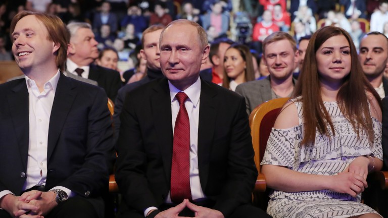 epa06593212 Russian President Vladimir Putin (C) and KVN Premier League host Alexander Maslyakov Jr. (L) attend the round of 16 of the premier league of KVN International Union at the Russian Army Theater in Moscow, Russia, late 09 March 2018, (issued 10 March 2018).. KVN ('Club of the Funny and Inventive People' ) - television humorous games in which teams of various collectives (educational institutions, universities, enterprises, cities, etc.) compete by giving funny answers to questions and showing prepared sketches, that originated in the Soviet Union. The first program appered on the First Soviet TV Channel 08 November 1961.  EPA/MIKHAIL KLIMENTYEV/SPUTNIK/KREMLIN POOL MANDATORY CREDIT