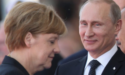 OUISTREHAM, FRANCE - JUNE 06:  In this file photo German Chancellor Angela Merkel and Russian President Vladimir Putin attend commeoration ceremonies marking the 70th anniversary of the D-day invasion of Nazi-occupied Normandy on June 6, 2014 in Ouistreham, France. Merkel and other leaders of NATO-member states are attending a NATO summit in Newport, Wales, from September 4-5, 2014, and Russia's active involvement in the war in eastern Ukraine is high on the summit agenda.  (Photo by Sean Gallup/Getty Images)
