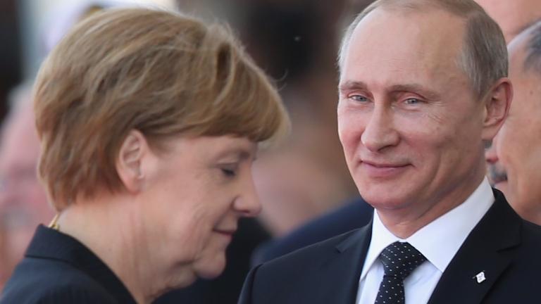 OUISTREHAM, FRANCE - JUNE 06:  In this file photo German Chancellor Angela Merkel and Russian President Vladimir Putin attend commeoration ceremonies marking the 70th anniversary of the D-day invasion of Nazi-occupied Normandy on June 6, 2014 in Ouistreham, France. Merkel and other leaders of NATO-member states are attending a NATO summit in Newport, Wales, from September 4-5, 2014, and Russia's active involvement in the war in eastern Ukraine is high on the summit agenda.  (Photo by Sean Gallup/Getty Images)