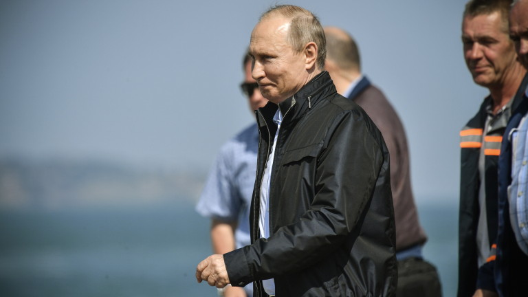 epa06738684 Russian President Vladimir Putin walks to take part in the opening ceremony of the road-and-rail Krymsky (Crimean) Bridge over the Kerch Strait, Crimea, 15 May 2018. Vladimir Putin inaugurated the 19-kilometers-long road-and-rail bridge that connects the Crimean peninsula, annexed by Russia from Ukraine in March 2014, with the Taman Peninsula of the Russian mainland. Public transport and automobiles traffic on Crimean Bridge will be launched in early hours of 16 May 2018.  EPA/ALEXANDER NEMENOV/POOL