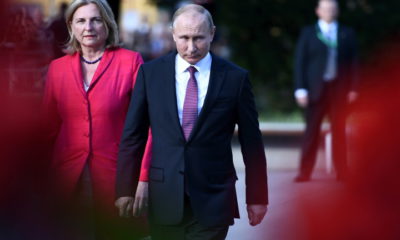 epa06787348 Russian President Vladimir Putin (C) and Austrian Foreign Minister Karin Kneissl during the wreath ceremony in front of the Soviet War Memorial at the Schwarzenbergplatz in Vienna, Austria, 05 June 2018. Putin is in Austria for an one-day official state visit.  EPA/CHRISTIAN BRUNA