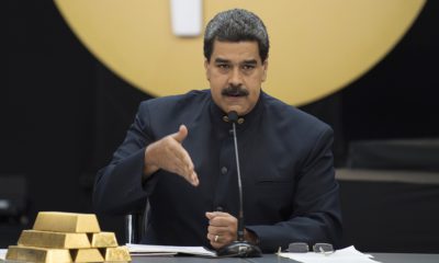 Nicolas Maduro, Venezuela's president gestures while he address to the media besides a pile of 12 kilogram gold ingots during a press conference on 'Petro' cryptocurrency in Caracas, Venezuela, on Thursday, March 22, 2018. U.S. President Trump banned U.S. purchases of 'Petro' cryptocurrency as part of a campaign to pressure the government of President Nicolas Maduro. Photographer: Carlos Becerra/Bloomberg