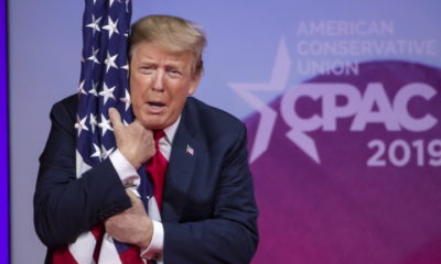 epa07409464 US President Donald J. Trump hugs a US flag before speaking at the 46th annual Conservative Political Action Conference (CPAC) at the Gaylord National Resort & Convention Center in National Harbor, Maryland, USA, 02 March 2019. Trump spoke on the final day of the four-day American Conservative Union's CPAC conference.  EPA/ERIK S. LESSER