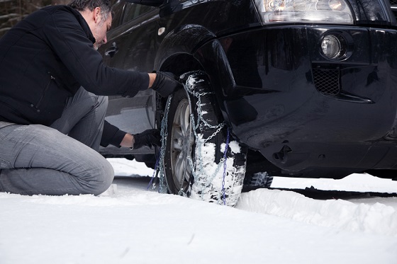 Man installing tire chains.