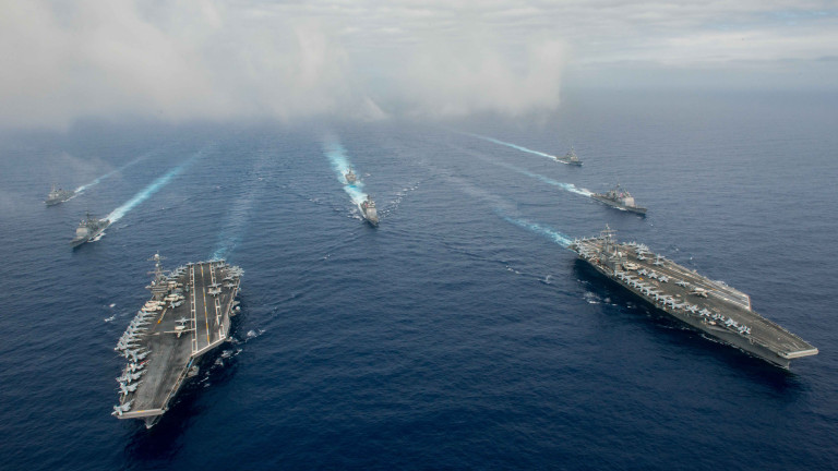 PHILIPPINE SEA - JUNE 18:  In this handout provided by the U.S. Navy, The Nimitz-class aircraft carriers USS John C. Stennis (CVN 74) (L) and USS Ronald Reagan (CVN 76) conduct dual aircraft carrier strike group operations in the U.S. 7th Fleet area of operations in support of security and stability in the Indo-Asia-Pacific.  (Photo by Specialist 3rd Class Jake Greenberg/U.S. Navy via Getty Images)
