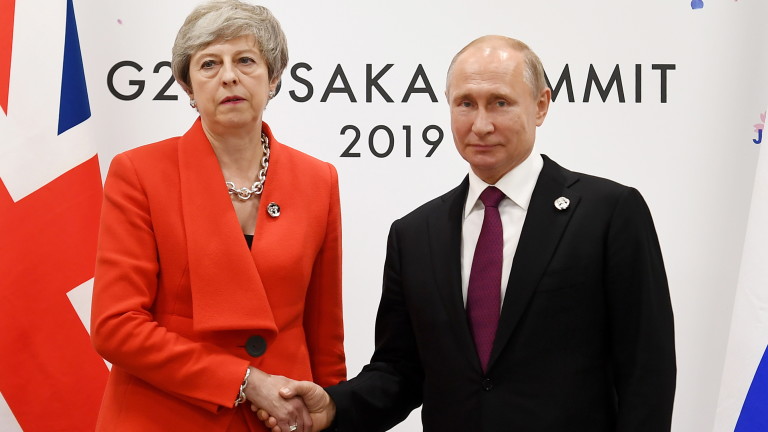epa07679428 British Prime Minister Theresa May (L) shakes hands with Russian President Vladimir Putin (R) during the first day of the G20 Summit in Osaka, Japan, 28 June 2019. It is the first time Japan is hosting the G20 Summit.  EPA/ANDY RAIN / POOL