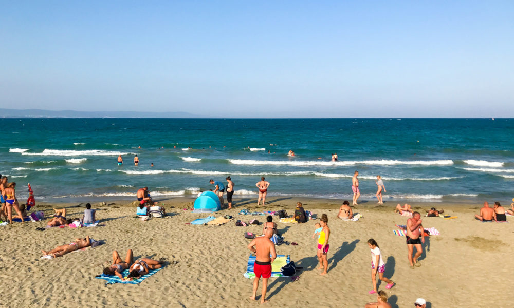 Pomorie, Bulgaria - September 01, 2019: People Relaxing On The Beach.